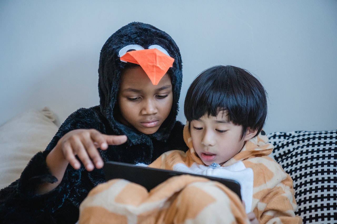 Kids playing Minecraft on tablet